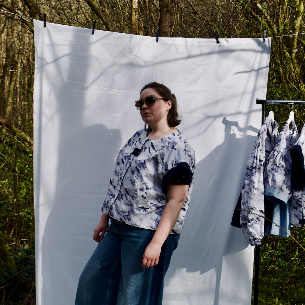 handmade, lightweight gilet vest for spring summer, light blues and white cute cloud fabric with navy sleeve trims, oversized casual fit, hidden zip closure, concealed pockets with popper fastening, side openings for inclusive sizing