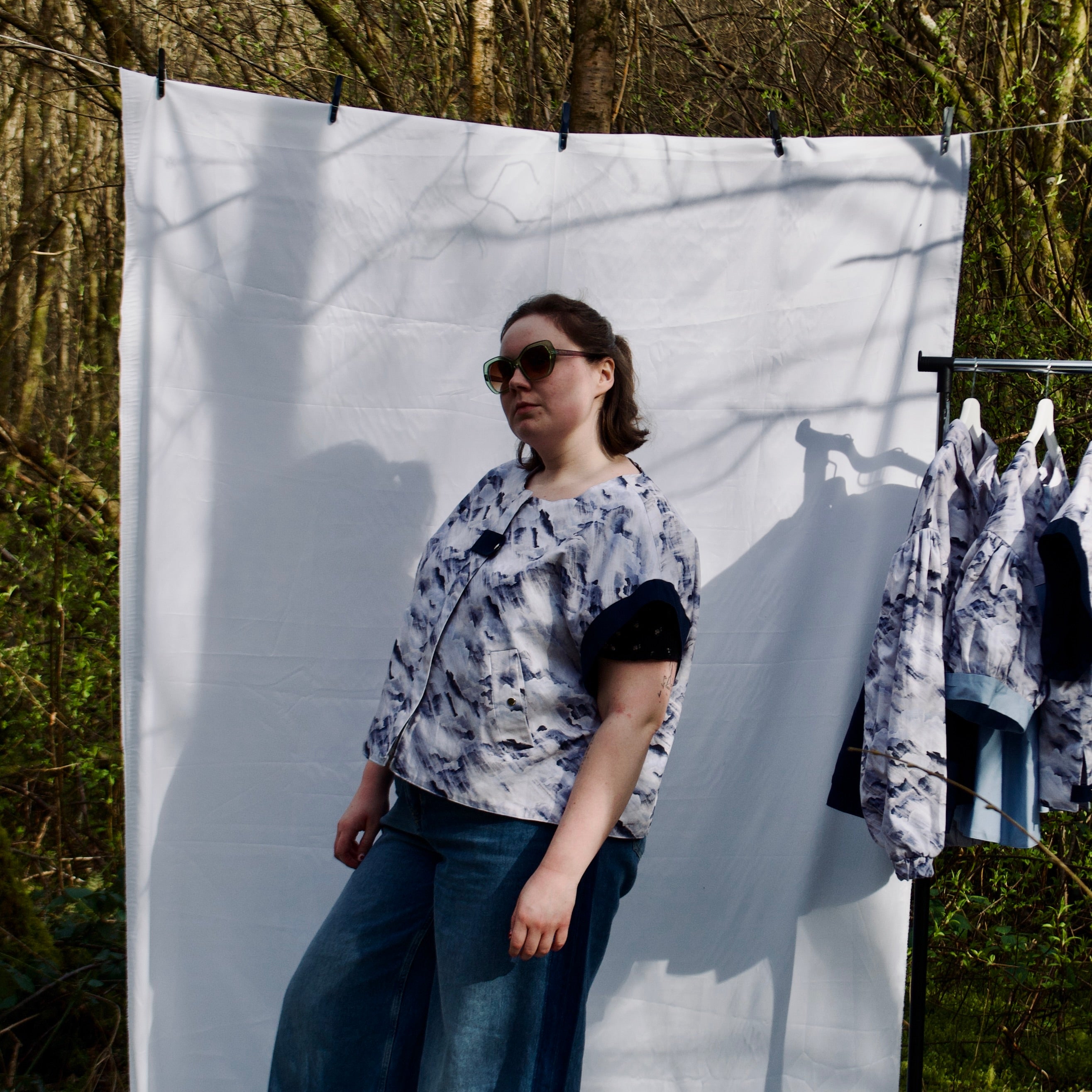 handmade, lightweight gilet vest for spring summer, light blues and white cute cloud fabric with navy sleeve trims, oversized casual fit, hidden zip closure, concealed pockets with popper fastening, side openings for inclusive sizing