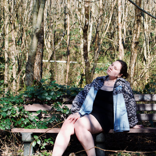 lightweight sustainable bomber jacket for women with black floral and animal print with blue contrast
