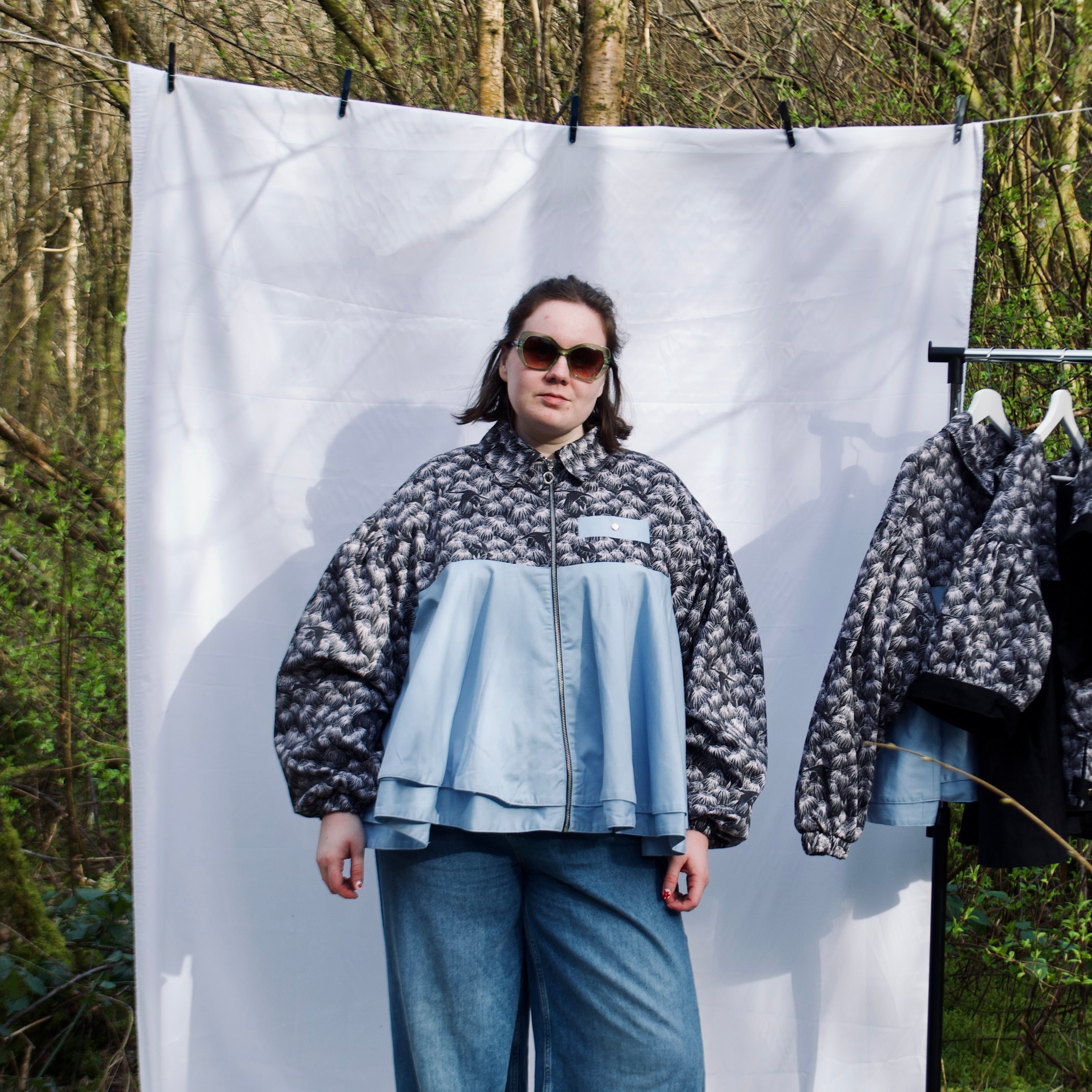 lightweight sustainable bomber jacket for women with black floral and animal print with blue contrast. long sleeves, elastic cuffs, collar, zip closure and breast pocket, oversized fit. casual spring summer jacket for women