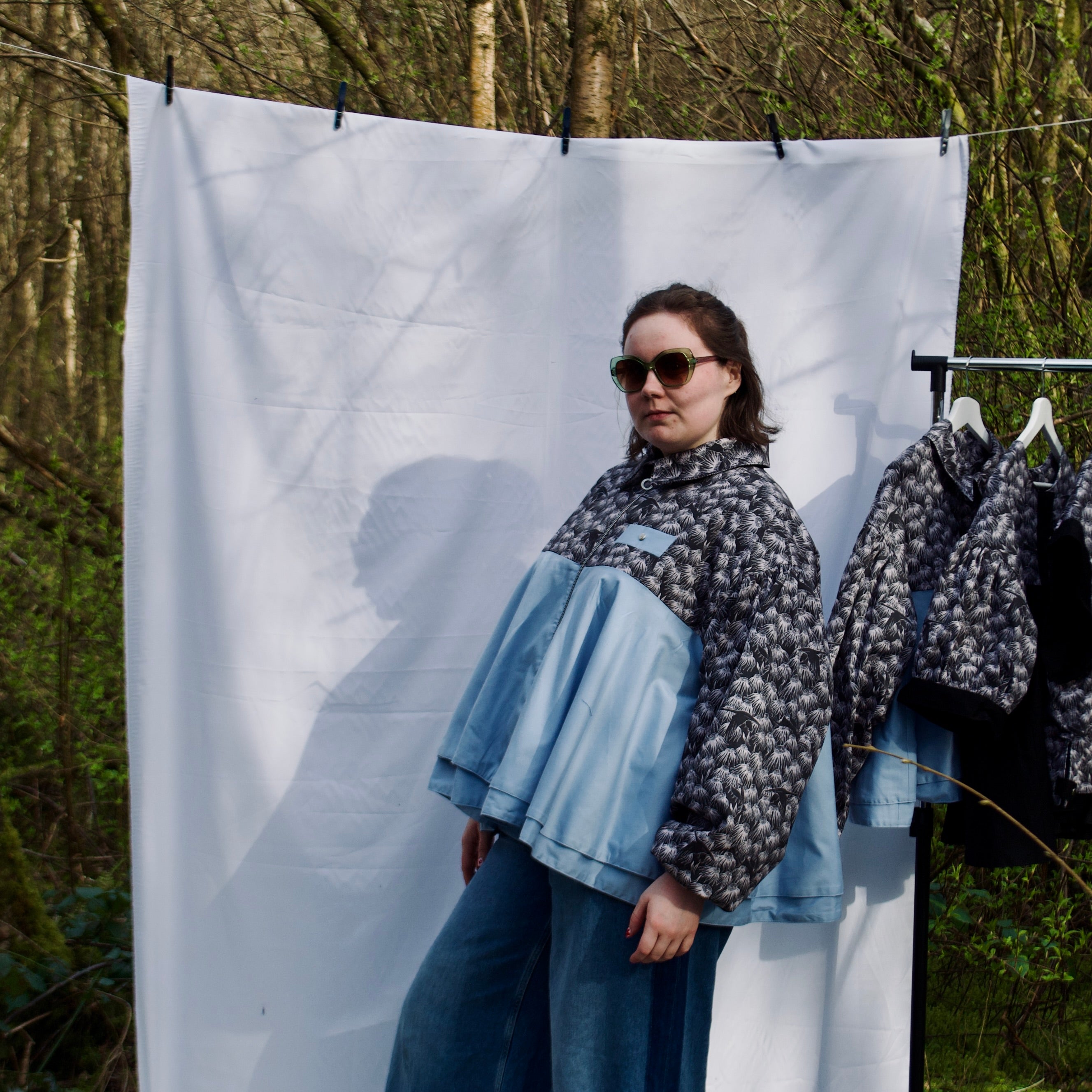 lightweight sustainable bomber jacket for women with black floral and animal print with blue contrast. long sleeves, elastic cuffs, collar, zip closure and breast pocket, oversized fit. casual spring summer jacket for women