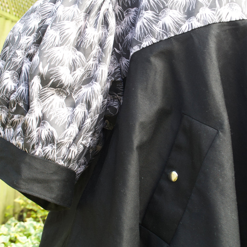 exclusive chic floral print on 100% cotton fabric, black and white floral print with black contrast ruffle, concealed pockets with popper fastening
