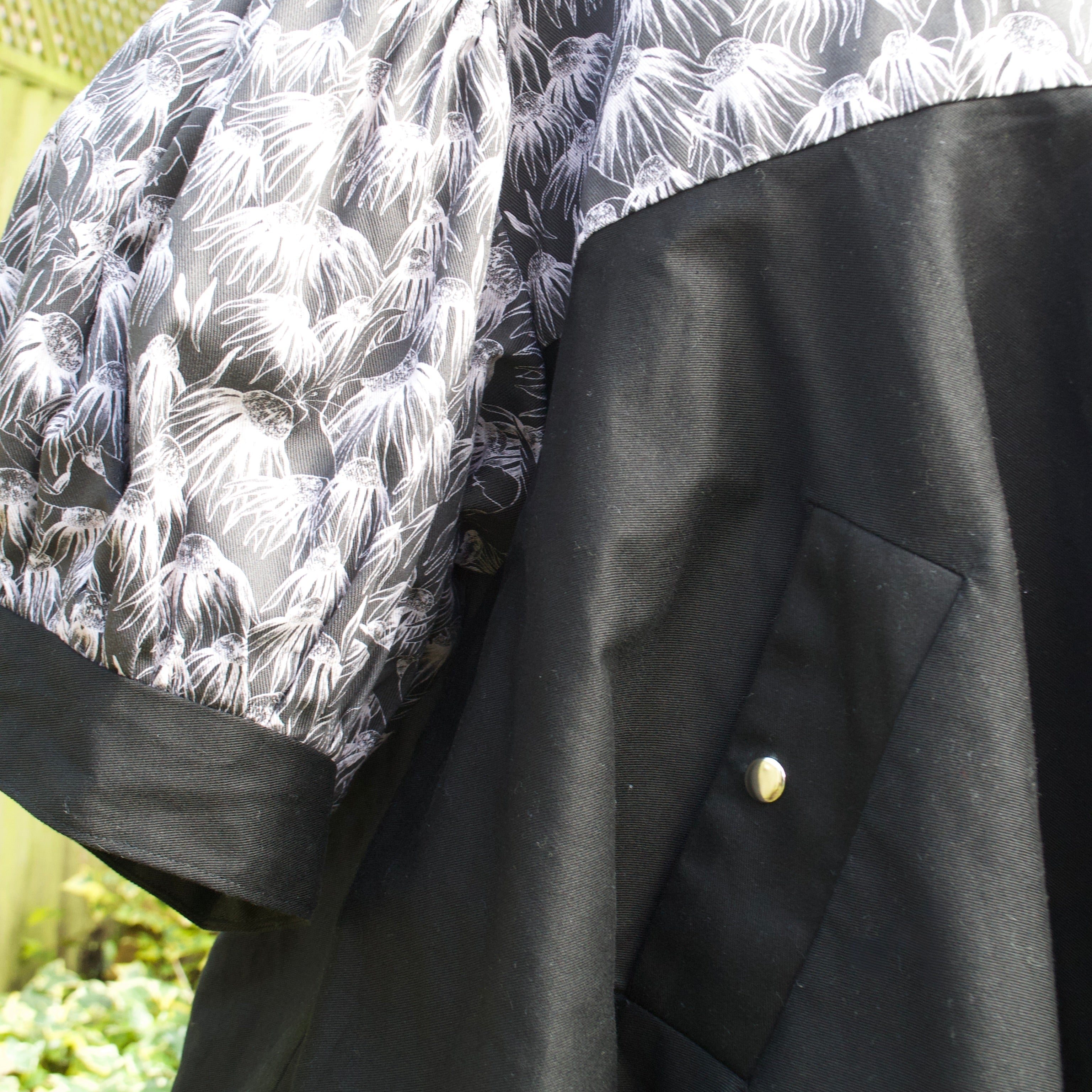 exclusive chic floral print on 100% cotton fabric, black and white floral print with black contrast ruffle, concealed pockets with popper fastening
