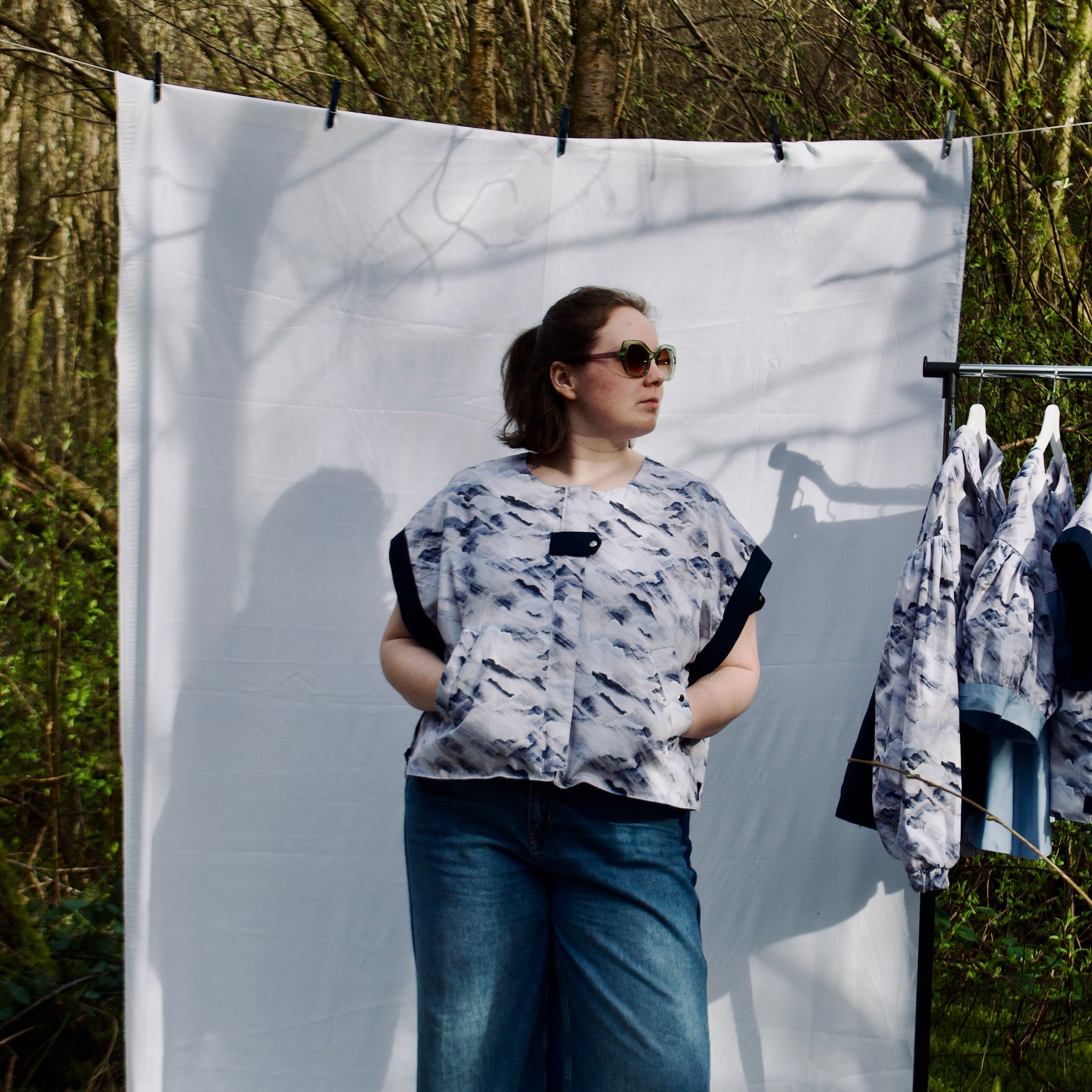 handmade, lightweight gilet vest for spring summer, light blues and white cute cloud fabric with navy sleeve trims, oversized casual fit, hidden zip closure, concealed pockets with popper fastening, side openings for inclusive sizing