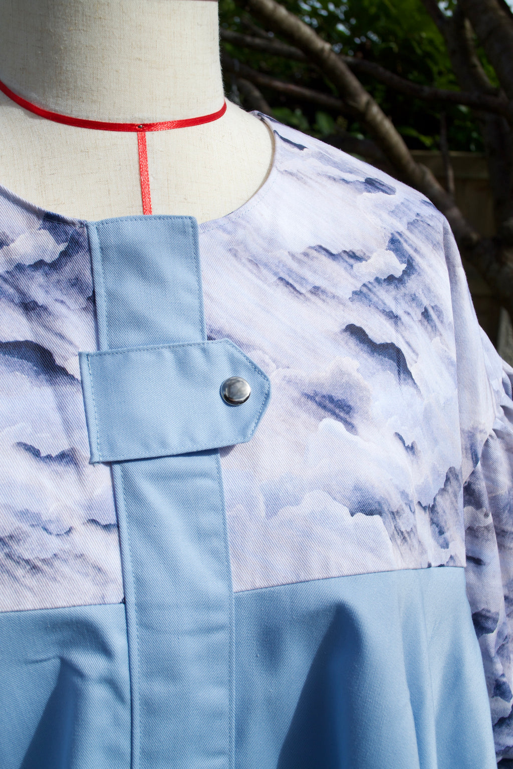 exclusive dreamy cloud print on 100% cotton fabric, light blue and white print with sky blue contrast ruffle, hidden zip closure and snap fastening