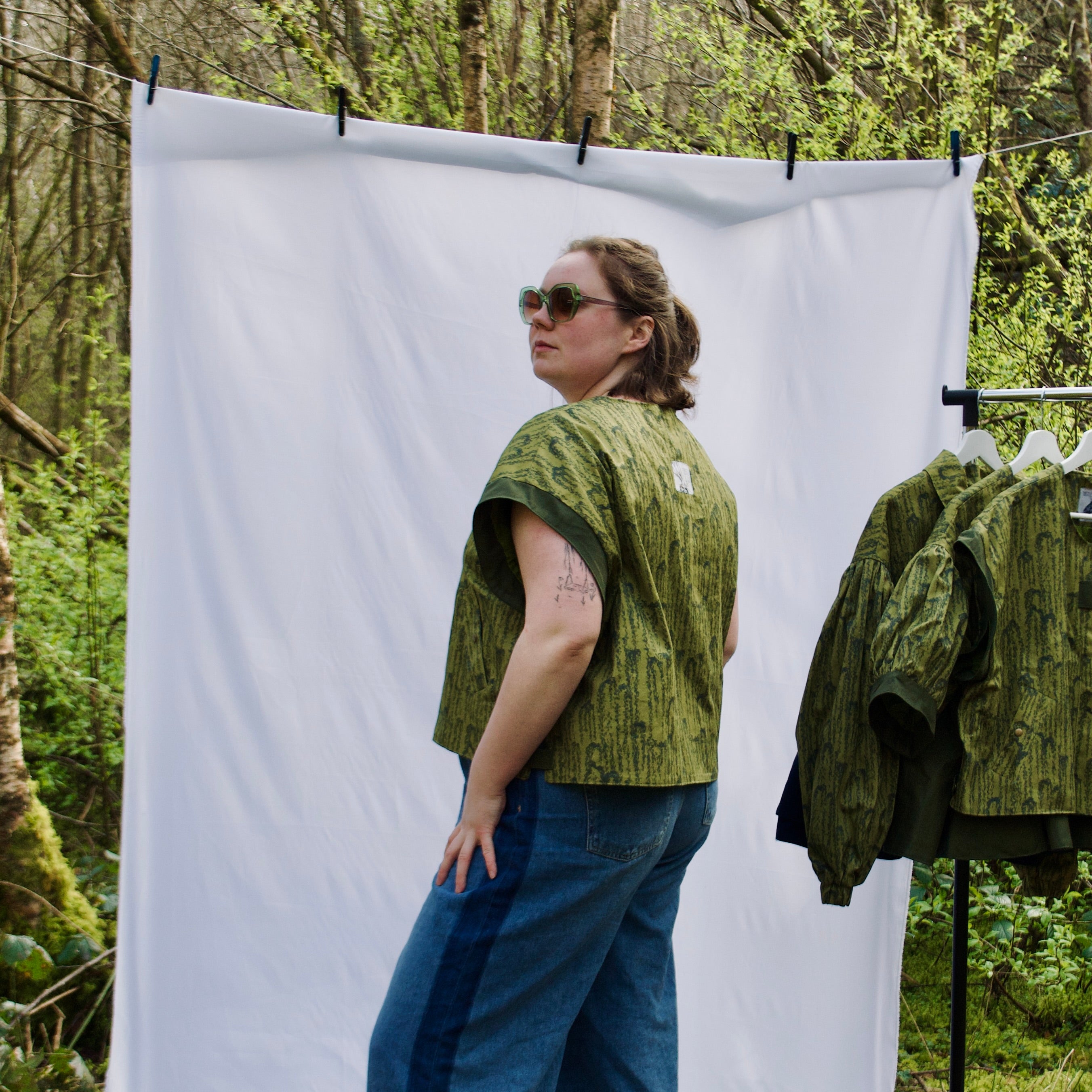 exclusive chic leaf print on 100% cotton fabric, olive and dark green luxury gilet with dark contrast trim, handmade, lightweight for spring summer, oversized casual fit, hidden zip closure, concealed pockets with popper fastening, side openings for inclusive sizing and added movement