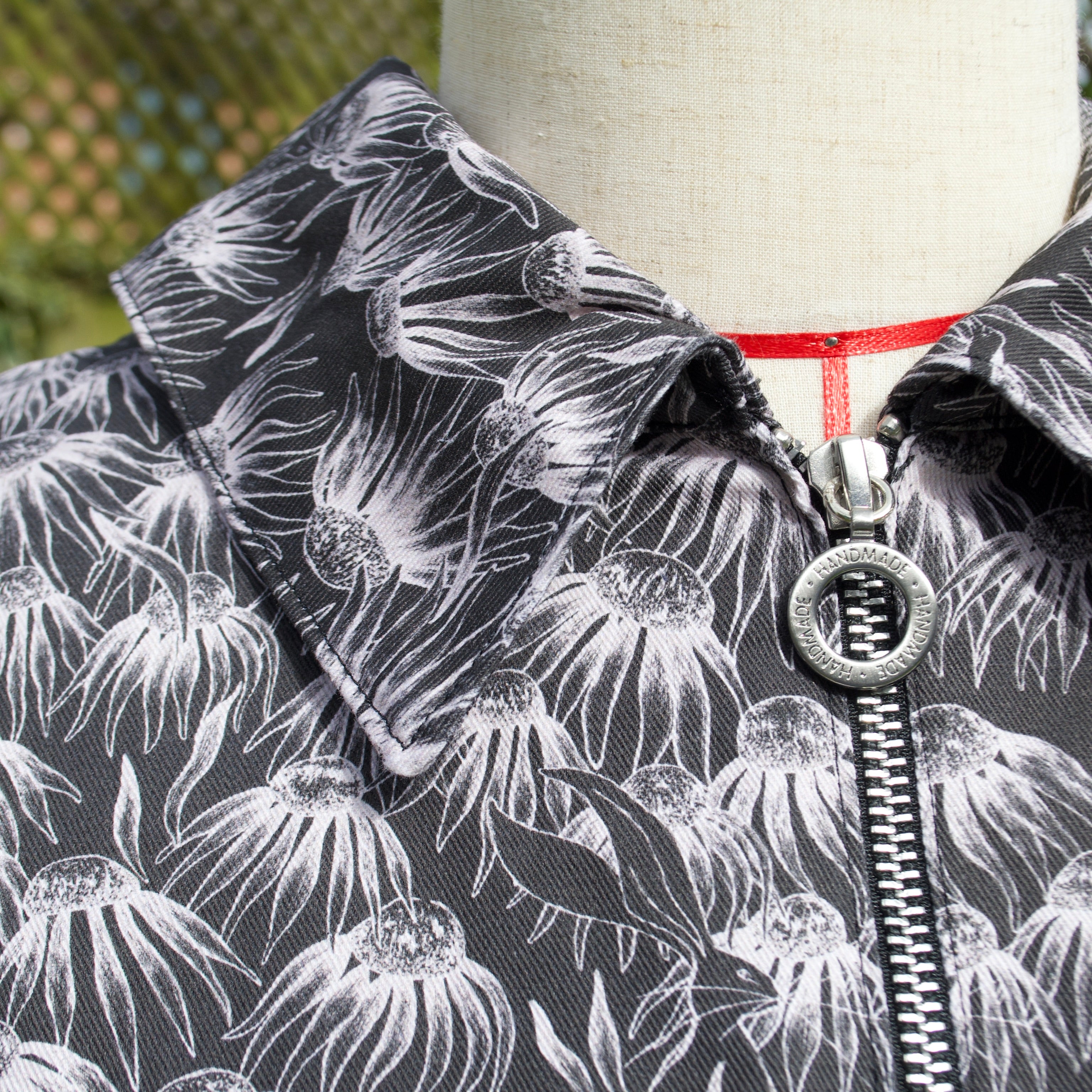 handmade sustainable lightweight jacket for women 100% cotton patterned fabric, black and white floral print with animals bomber jacket with collar and breast pocket, popper fastenings and zip closure 

