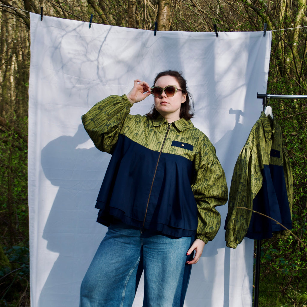 casual spring summer bomber jacket for women handmade with green willow leaves print with navy contrast long sleeves, elastic cuffs, collar, zip closure and contrast breast pocket, oversized fit. sustainable handmade jacket for ladies