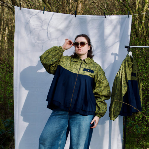 casual spring summer bomber jacket for women handmade with green willow leaves print with navy contrast long sleeves, elastic cuffs, collar, zip closure and contrast breast pocket, oversized fit. sustainable handmade jacket for ladies