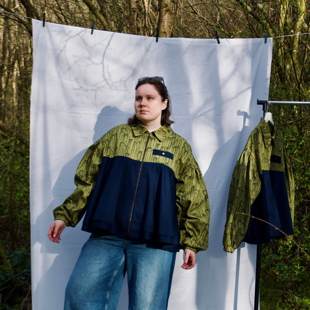 casual spring summer bomber jacket for women handmade with green willow leaves print with navy contrast long sleeves, elastic cuffs, collar, zip closure and contrast breast pocket, oversized fit. sustainable handmade jacket for ladies