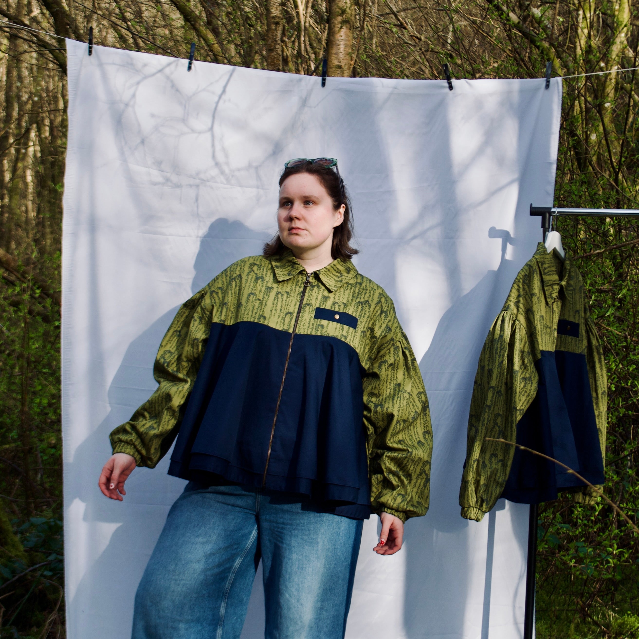 casual spring summer bomber jacket for women handmade with green willow leaves print with navy contrast long sleeves, elastic cuffs, collar, zip closure and contrast breast pocket, oversized fit. sustainable handmade jacket for ladies