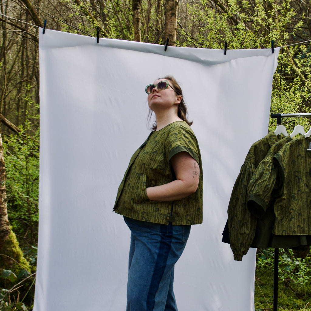 exclusive chic leaf print on 100% cotton fabric, olive and dark green luxury gilet with dark contrast trim, handmade, lightweight for spring summer, oversized casual fit, hidden zip closure, concealed pockets with popper fastening, side openings for inclusive sizing and added movement