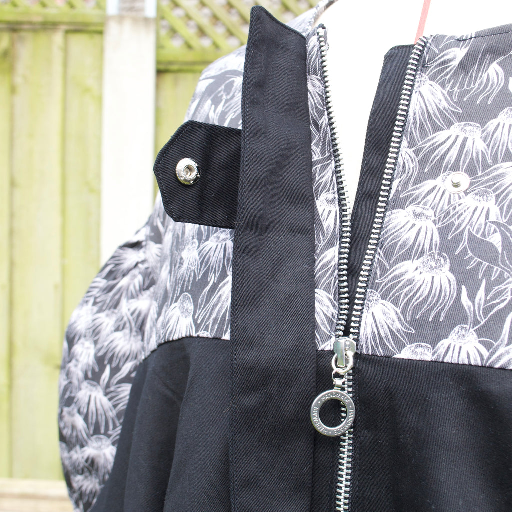 exclusive chic floral print on 100% cotton fabric, black and white print with black contrast ruffle, hidden zip closure and snap fastening
