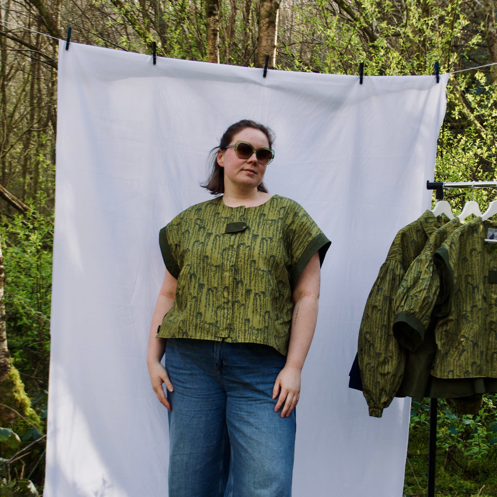 exclusive chic leaf print on 100% cotton fabric, olive and dark green luxury gilet with dark contrast trim, handmade, lightweight for spring summer, oversized casual fit, hidden zip closure, concealed pockets with popper fastening, side openings for inclusive sizing and added movement