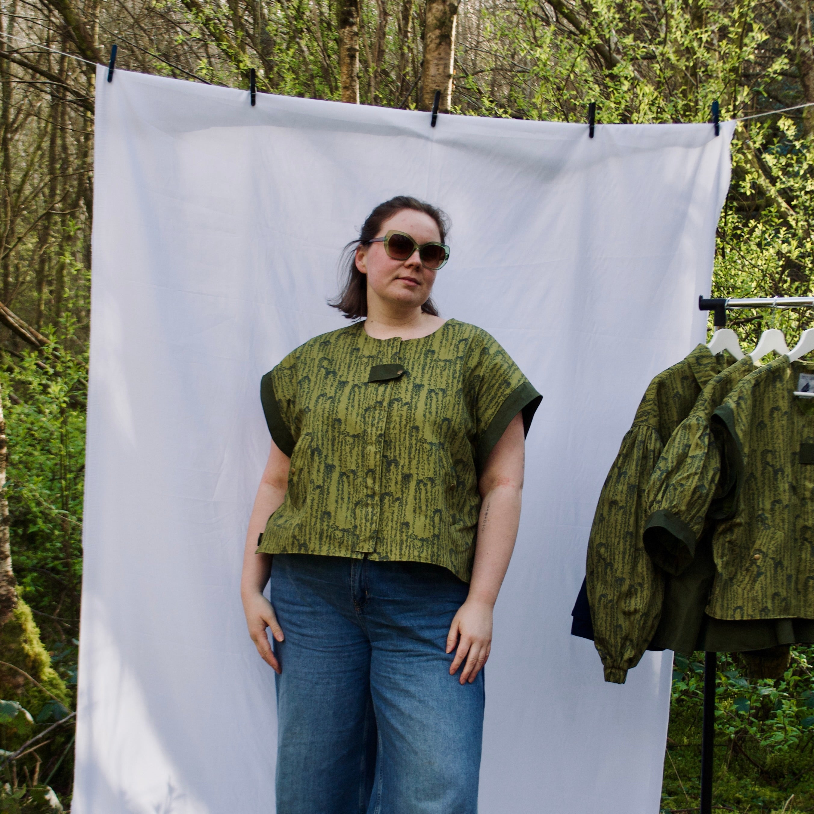 exclusive chic leaf print on 100% cotton fabric, olive and dark green luxury gilet with dark contrast trim, handmade, lightweight for spring summer, oversized casual fit, hidden zip closure, concealed pockets with popper fastening, side openings for inclusive sizing and added movement