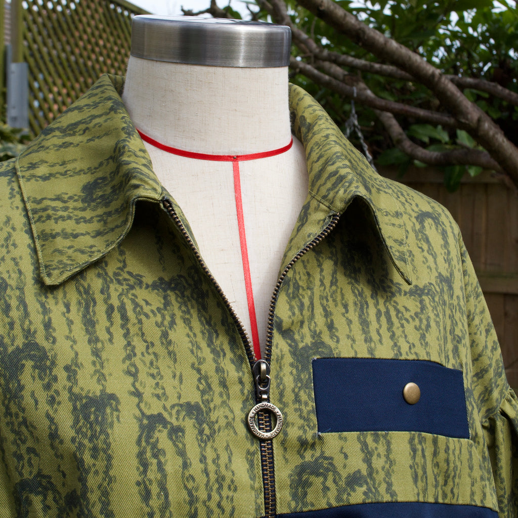 handmade sustainable lightweight jacket for women 100% cotton exclusive patterned fabric, olive green chartreuse bomber jacket with collar and contrast navy breast pocket, popper fastenings and bronze brass zip closure perfect for spring summer