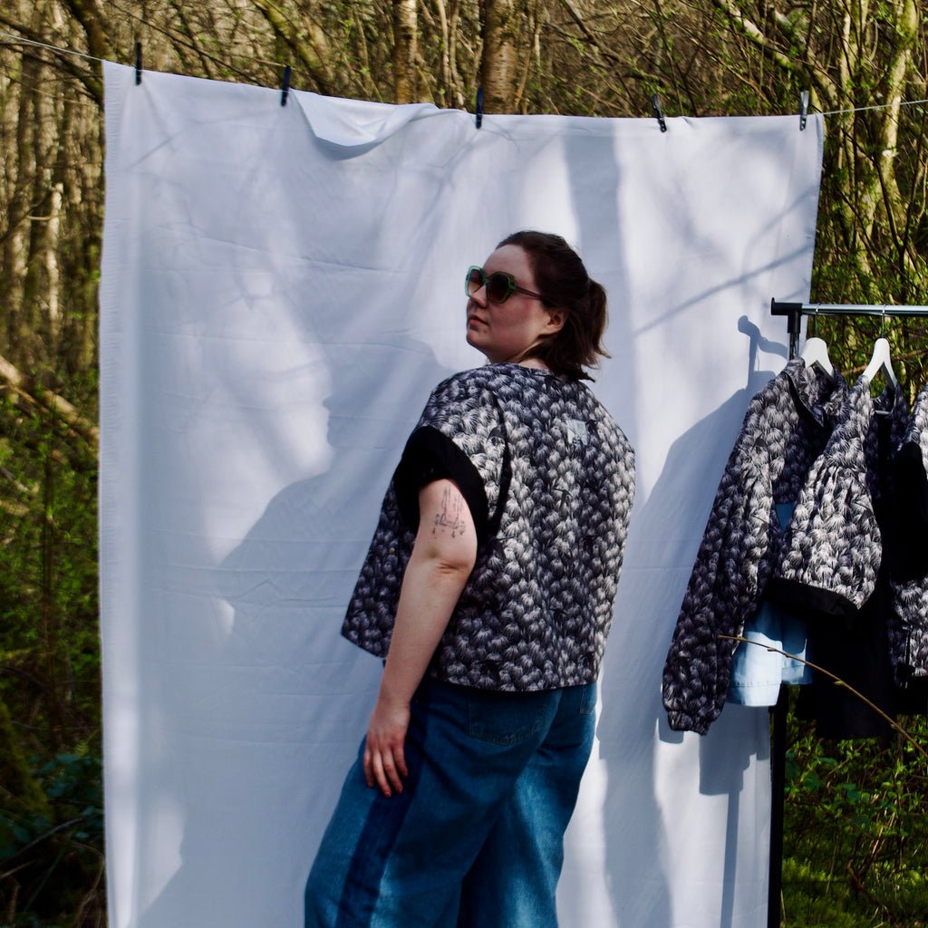 exclusive chic floral print on 100% cotton fabric, black and white whimsical gilet vest with black contrast trim, handmade, lightweight for spring summer, oversized casual fit, hidden zip closure, concealed pockets with popper fastening, side openings for inclusive sizing and added movement