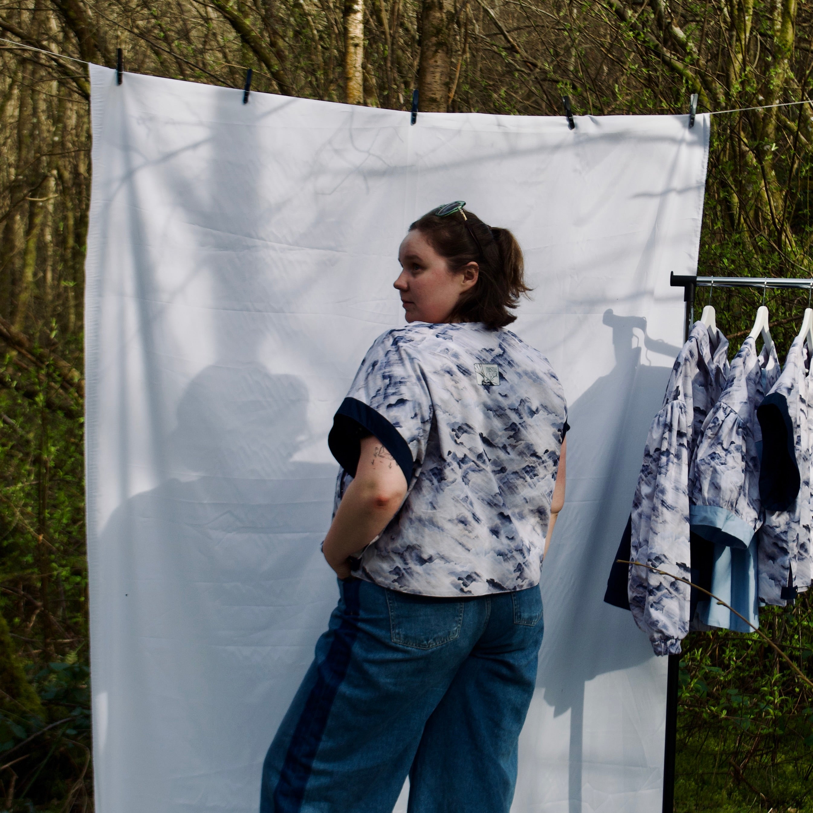 handmade, lightweight gilet vest for spring summer, light blues and white cute cloud fabric with navy sleeve trims, oversized casual fit, hidden zip closure, concealed pockets with popper fastening, side openings for inclusive sizing