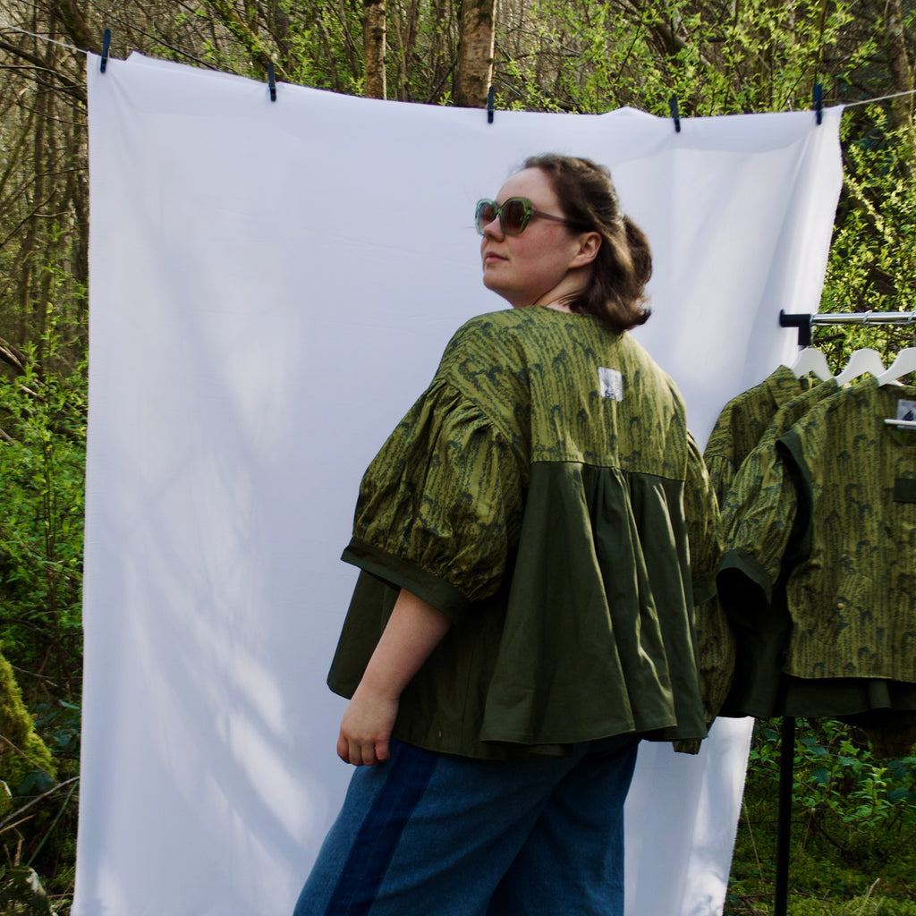 unique short sleeve jacket for women with luxury greens, sustainable lightweight 100% cotton fabric, perfect for spring summer, handmade with hidden zip closure and pockets with snap fastening, oversized fit, unique gathered ruffle silhouette. 