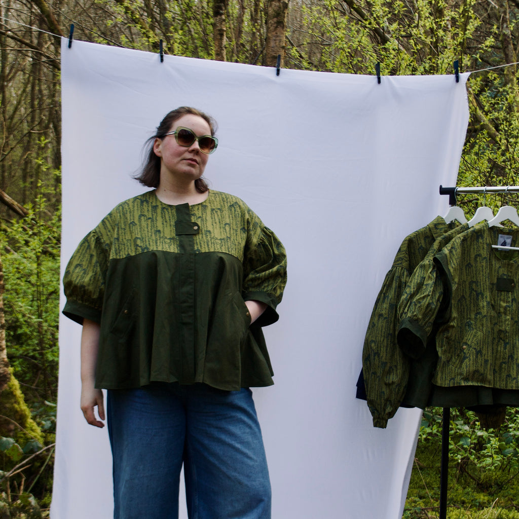 unique short sleeve jacket for women with luxury greens, sustainable lightweight 100% cotton fabric, perfect for spring summer, handmade with hidden zip closure and pockets with snap fastening, oversized fit, unique gathered ruffle silhouette. 
