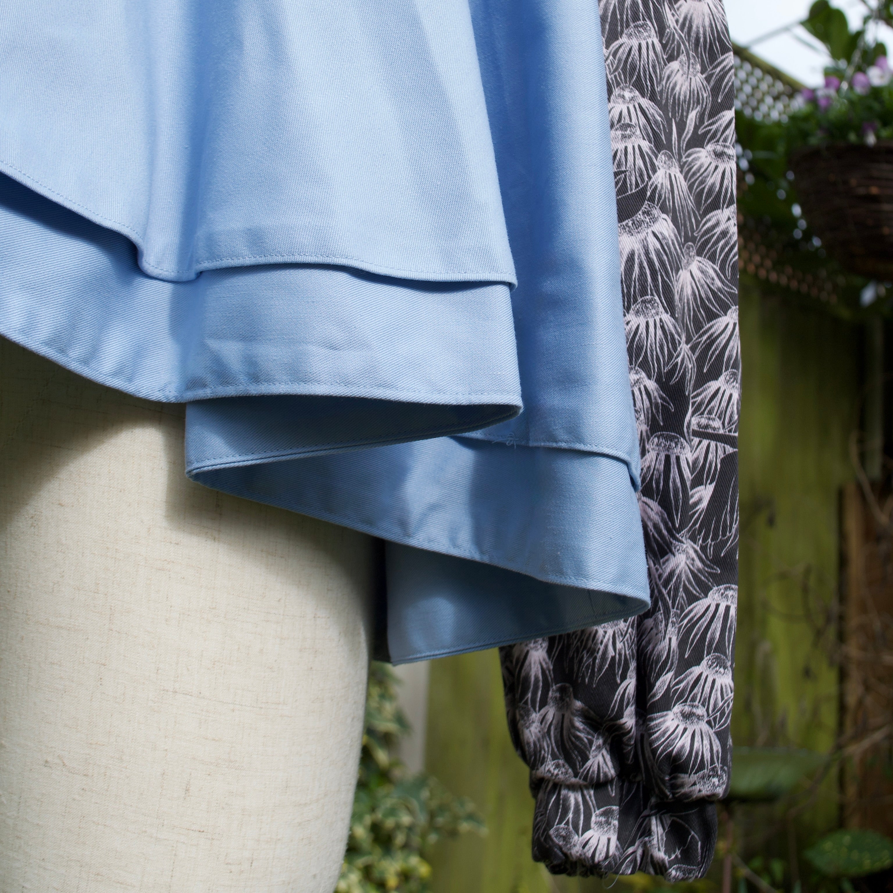 whimsical floral print, elasticated cuff, oversized sleeve, circle skirt jacket with extra ruffle, black and white pattern with sky-blue contrast spring summer jacket for women