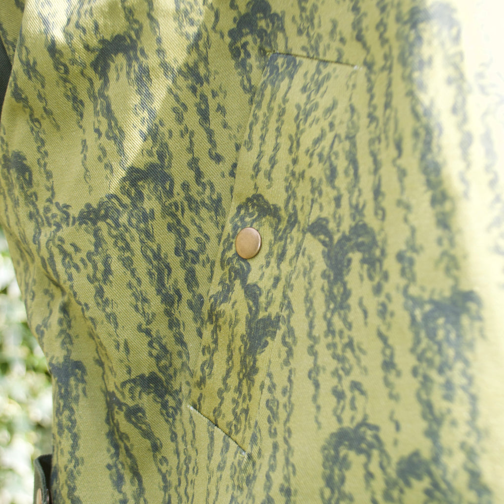 handmade, lightweight gilet vest for spring summer, olive green, chartreuse, forest green leaf fabric, oversized casual fit, hidden zip closure, concealed pockets with popper fastening, side openings for inclusive sizing
